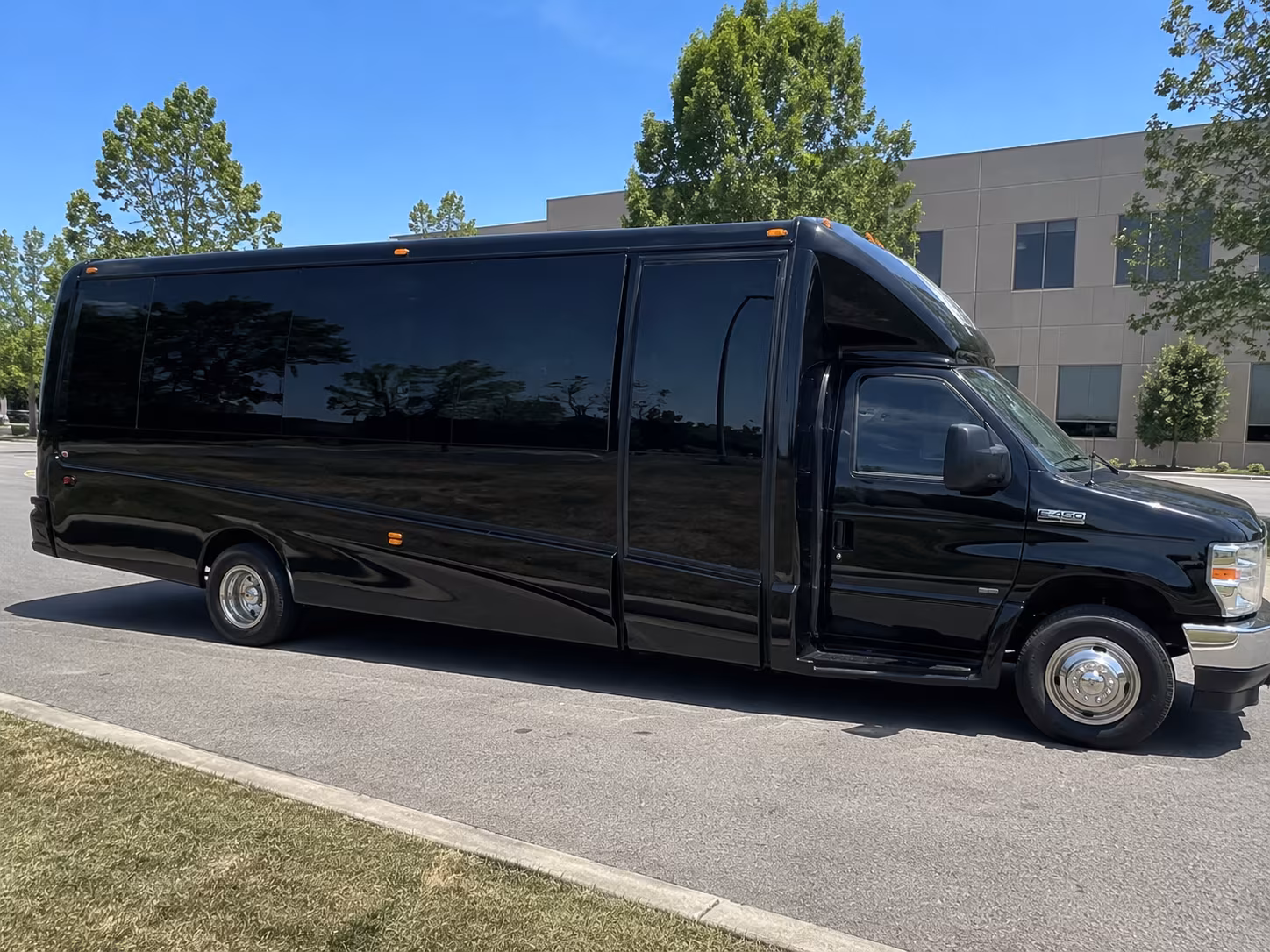 Group beside a Mercedes Sprinter limo in Akron
